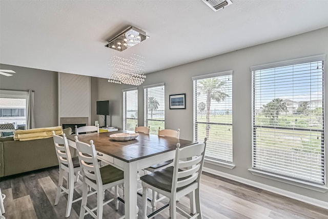 8111 Broadway St Unit 7, Galveston, TX 77554 - dining space with wood finished floors, baseboards, and a chandelier