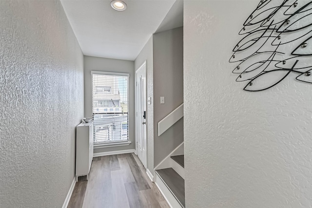 8111 Broadway St Unit 7, Galveston, TX 77554 - doorway to outside with wood finished floors, a textured wall, baseboards, and recessed lighting