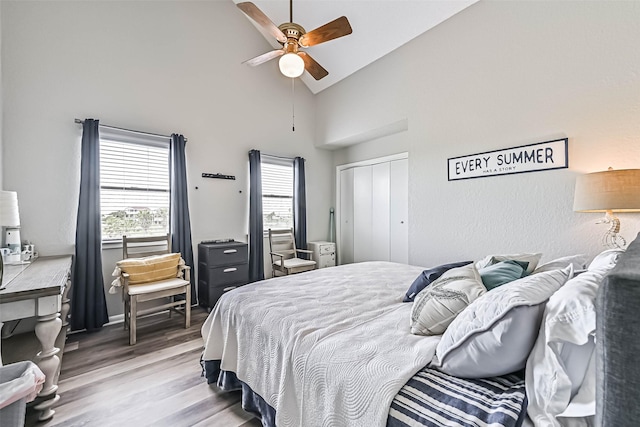 8111 Broadway St Unit 7, Galveston, TX 77554 - bedroom with wood finished floors, high vaulted ceiling, a closet, and ceiling fan