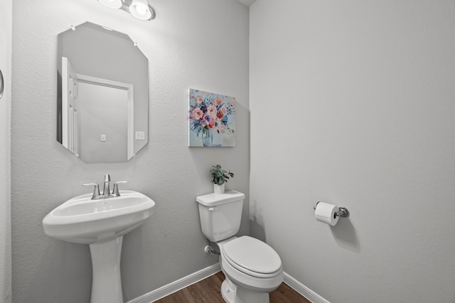 10902 Webber Ln, Texas City, TX 77591 - bathroom featuring wood finished floors, toilet, and baseboards