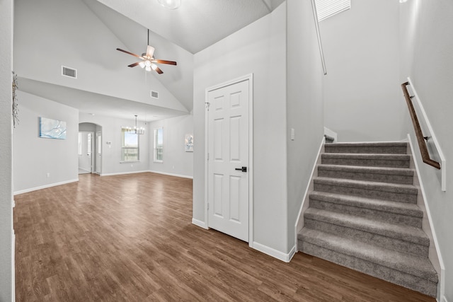 10902 Webber Ln, Texas City, TX 77591 - unfurnished living room with wood finished floors, a ceiling fan, a chandelier, stairs, and high vaulted ceiling