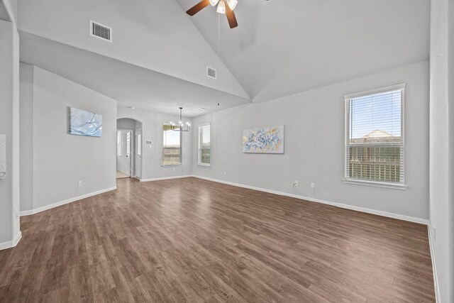 10902 Webber Ln, Texas City, TX 77591 - unfurnished living room featuring a ceiling fan, dark wood-style floors, arched walkways, a chandelier, and baseboards
