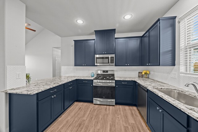 10902 Webber Ln, Texas City, TX 77591 - kitchen featuring stainless steel appliances, a sink, light wood-style floors, decorative backsplash, and recessed lighting