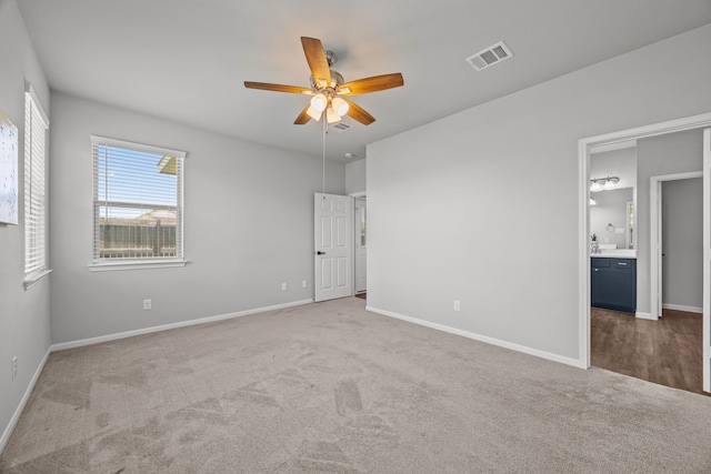 10902 Webber Ln, Texas City, TX 77591 - unfurnished bedroom featuring carpet, baseboards, ensuite bath, and a ceiling fan