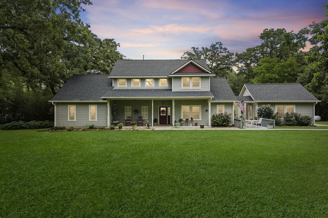 6803 E Treaschwig Rd, Spring, TX 77373 - view of front of house with a front lawn, a patio, and roof with shingles