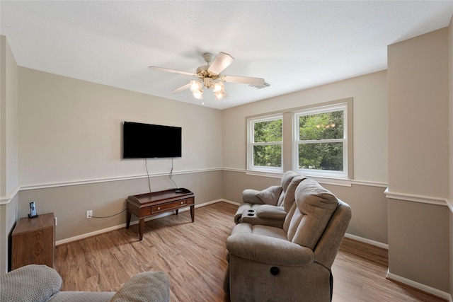 6803 E Treaschwig Rd, Spring, TX 77373 - living area with wood finished floors, baseboards, and a ceiling fan