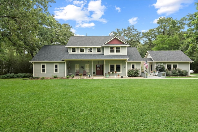 6803 E Treaschwig Rd, Spring, TX 77373 - view of front of home with a front lawn, a patio, and a shingled roof