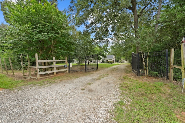 6803 E Treaschwig Rd, Spring, TX 77373 - view of dirt / gravel road with a gate and a gated entry
