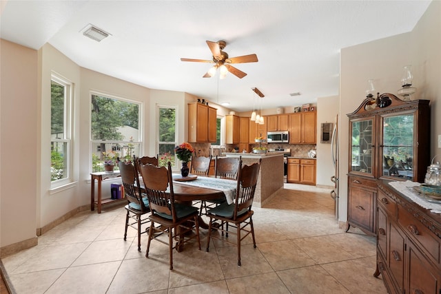 6803 E Treaschwig Rd, Spring, TX 77373 - dining room featuring ceiling fan, light tile patterned floors, and baseboards
