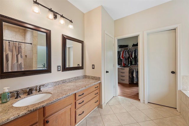 6803 E Treaschwig Rd, Spring, TX 77373 - full bathroom featuring vanity, a tile shower, tile patterned floors, and a spacious closet