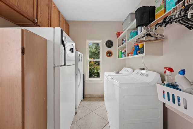 6803 E Treaschwig Rd, Spring, TX 77373 - washroom featuring washing machine and dryer, light tile patterned flooring, cabinet space, and baseboards