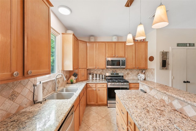 6803 E Treaschwig Rd, Spring, TX 77373 - kitchen featuring stainless steel appliances, a sink, decorative backsplash, light stone countertops, and pendant lighting