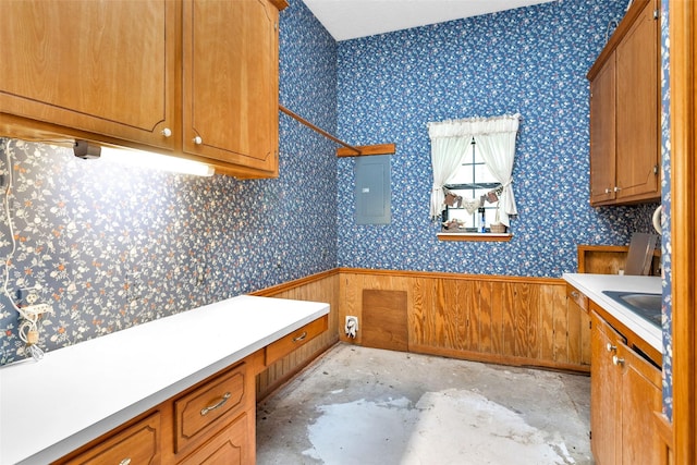 24614 Spruce, Huntsville, TX 77320 - laundry room featuring electric panel, a sink, and wainscoting
