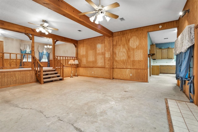 24614 Spruce, Huntsville, TX 77320 - empty room with wooden walls, beamed ceiling, stairs, a ceiling fan, and a chandelier
