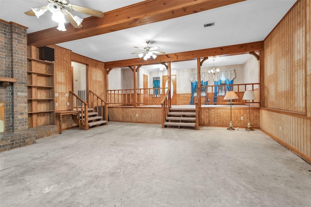 24614 Spruce, Huntsville, TX 77320 - unfurnished living room with stairway, wood walls, ceiling fan, a chandelier, and unfinished concrete floors
