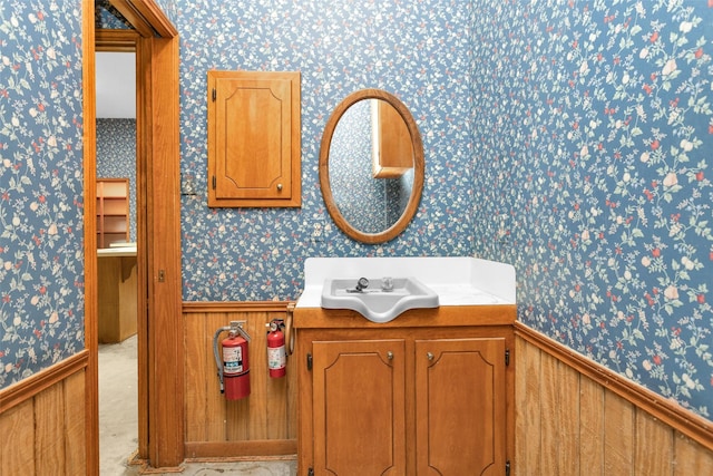 24614 Spruce, Huntsville, TX 77320 - bathroom with wallpapered walls, a wainscoted wall, and vanity