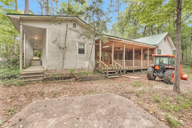 24614 Spruce, Huntsville, TX 77320 - back of property featuring a ceiling fan and metal roof