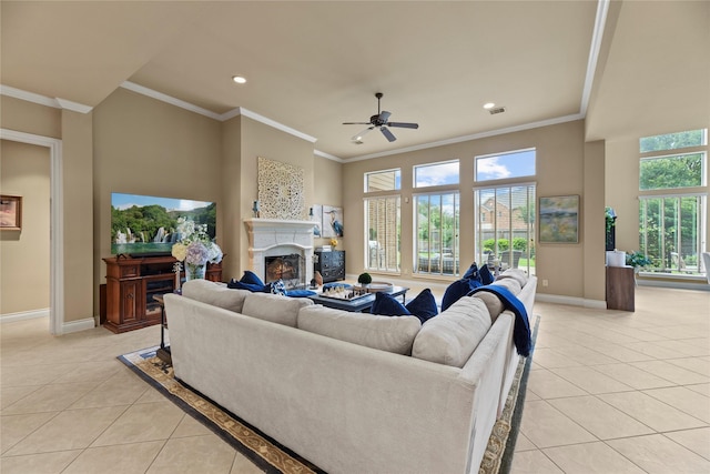 11310 Stonecreek Bend Ln, Cypress, TX 77433 - living area with light tile patterned floors, baseboards, a warm lit fireplace, ornamental molding, and ceiling fan