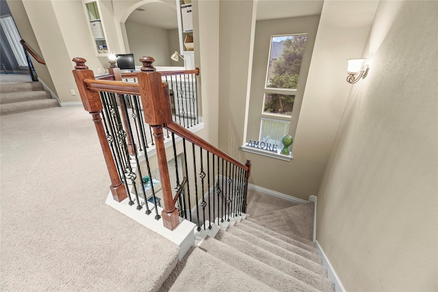 11310 Stonecreek Bend Ln, Cypress, TX 77433 - staircase with carpet flooring, baseboards, and arched walkways