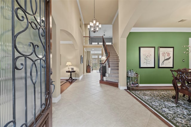 11310 Stonecreek Bend Ln, Cypress, TX 77433 - foyer entrance featuring light tile patterned flooring, a chandelier, arched walkways, stairway, and baseboards