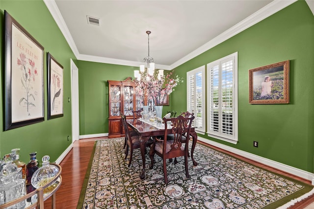 11310 Stonecreek Bend Ln, Cypress, TX 77433 - dining space with a chandelier, wood finished floors, ornamental molding, and baseboards