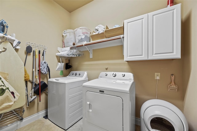 11310 Stonecreek Bend Ln, Cypress, TX 77433 - clothes washing area featuring washer and dryer, cabinet space, baseboards, and light tile patterned flooring