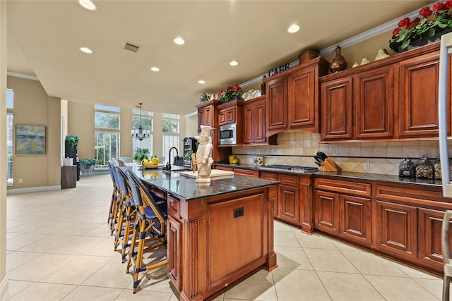 11310 Stonecreek Bend Ln, Cypress, TX 77433 - kitchen featuring stainless steel appliances, light tile patterned floors, a breakfast bar, decorative backsplash, and recessed lighting