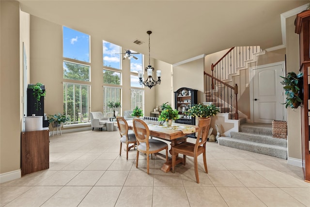 11310 Stonecreek Bend Ln, Cypress, TX 77433 - dining area featuring a high ceiling, stairway, light tile patterned floors, baseboards, and a chandelier