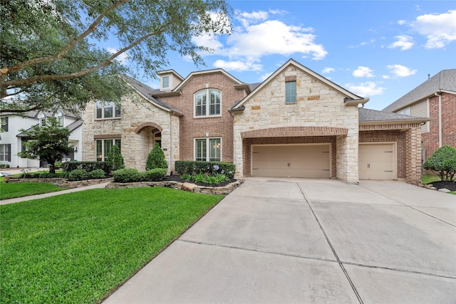 11310 Stonecreek Bend Ln, Cypress, TX 77433 - view of front of home featuring concrete driveway, a front lawn, stone siding, brick siding, and an attached garage