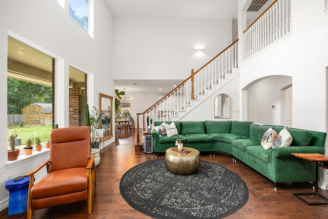 14742 Timbergreen Dr, Magnolia, TX 77355 - living area with a high ceiling, arched walkways, plenty of natural light, stairway, and wood finished floors