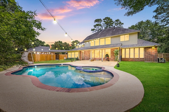14742 Timbergreen Dr, Magnolia, TX 77355 - pool at dusk featuring a patio, a water slide, and a pool with connected hot tub
