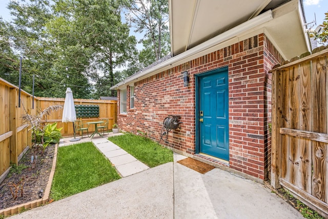 14742 Timbergreen Dr, Magnolia, TX 77355 - entrance to property with brick siding, a patio, and fence