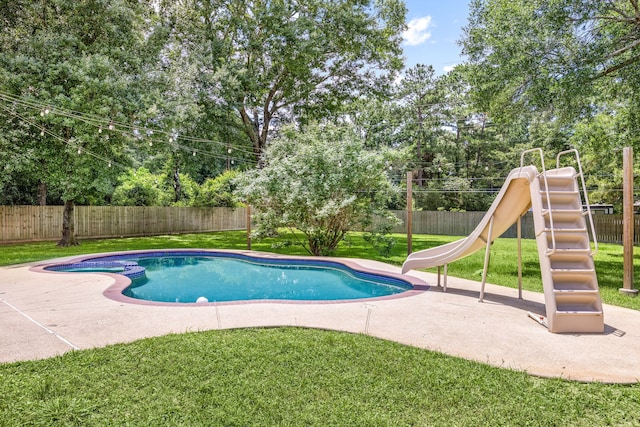 14742 Timbergreen Dr, Magnolia, TX 77355 - view of pool featuring a water slide, a playground, a patio, view of wooded area, and a pool with connected hot tub