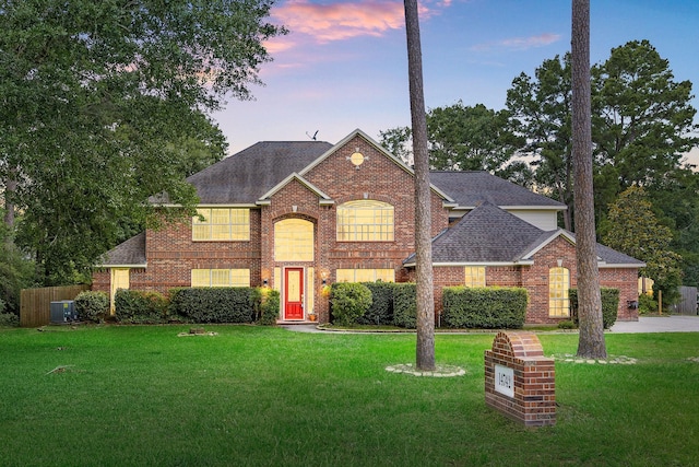14742 Timbergreen Dr, Magnolia, TX 77355 - traditional-style home featuring a shingled roof, a front lawn, and brick siding