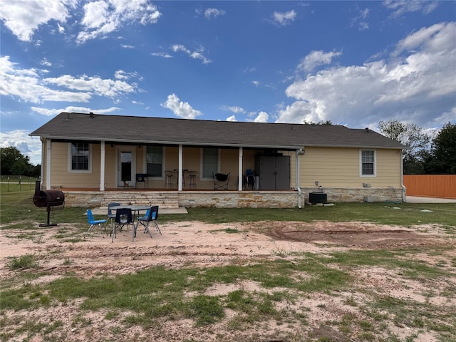 3876 Hummingbird, Bedias, TX 77831 - rear view of property with fence, central AC unit, and covered porch