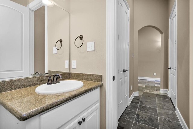 253 Capetown, Montgomery, TX 77356 - bathroom featuring vanity, stone finish flooring, and baseboards