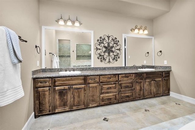 253 Capetown, Montgomery, TX 77356 - bathroom with double vanity, tile patterned flooring, a tile shower, and baseboards