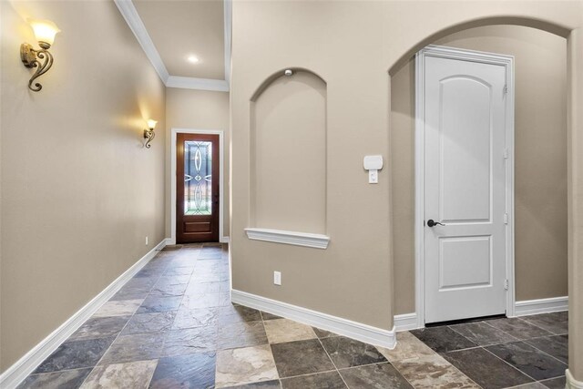 253 Capetown, Montgomery, TX 77356 - entrance foyer featuring ornamental molding, stone tile flooring, baseboards, and arched walkways