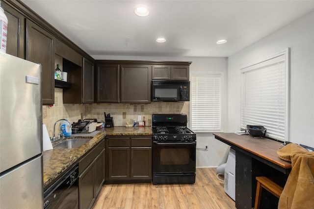 3824 Tower Rd, Santa Fe, TX 77517 - kitchen featuring black appliances, a sink, light wood-type flooring, dark brown cabinets, and recessed lighting