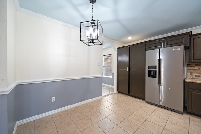 20151 Pioneer Ridge Dr, Cypress, TX 77433 - kitchen featuring stainless steel fridge with ice dispenser, crown molding, arched walkways, dark brown cabinetry, and light tile patterned flooring