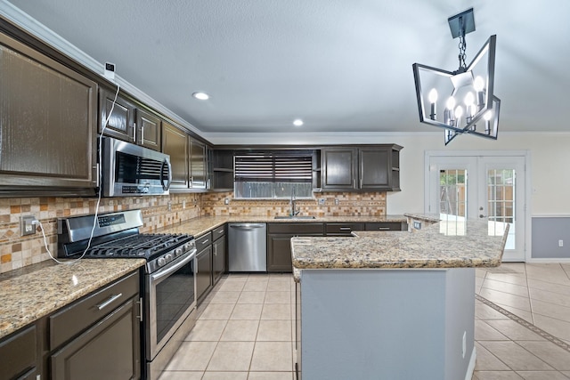 20151 Pioneer Ridge Dr, Cypress, TX 77433 - kitchen featuring appliances with stainless steel finishes, a sink, light tile patterned floors, open shelves, and ornamental molding