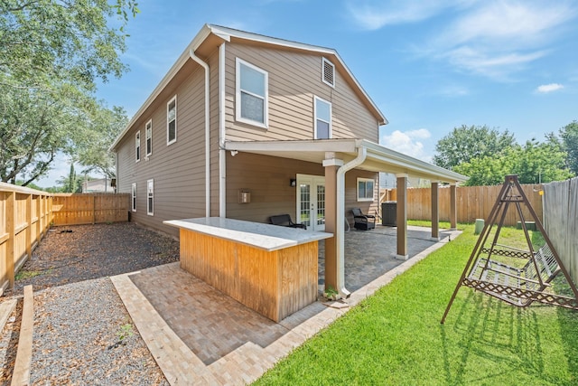 20151 Pioneer Ridge Dr, Cypress, TX 77433 - back of property with french doors and a patio