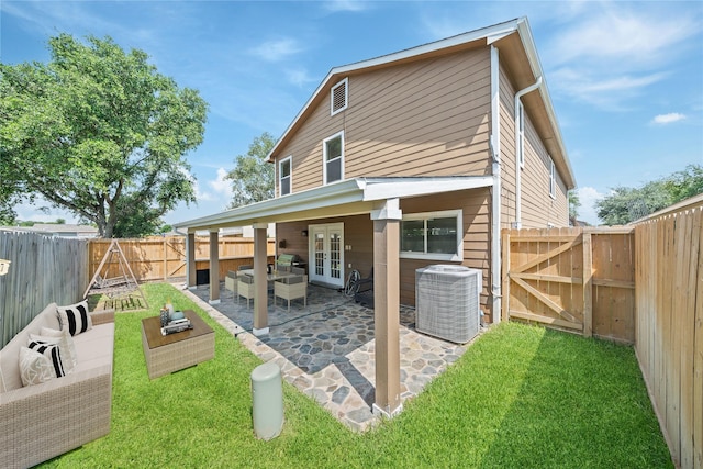 20151 Pioneer Ridge Dr, Cypress, TX 77433 - rear view of property featuring french doors, central air condition unit, a gate, a patio area, and an outdoor living space