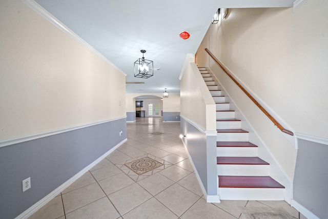 20151 Pioneer Ridge Dr, Cypress, TX 77433 - stairway with arched walkways, tile patterned floors, baseboards, a chandelier, and crown molding