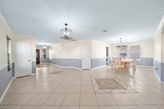 20151 Pioneer Ridge Dr, Cypress, TX 77433 - unfurnished dining area with a chandelier, baseboards, light tile patterned floors, ornamental molding, and plenty of natural light