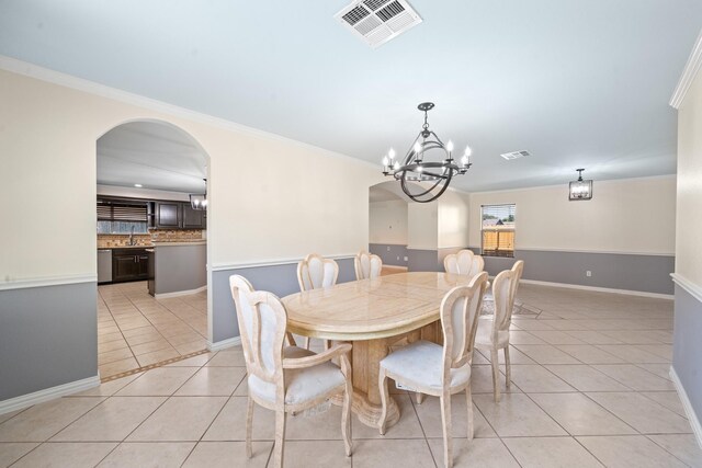 20151 Pioneer Ridge Dr, Cypress, TX 77433 - dining space featuring light tile patterned floors, ornamental molding, a chandelier, baseboards, and arched walkways
