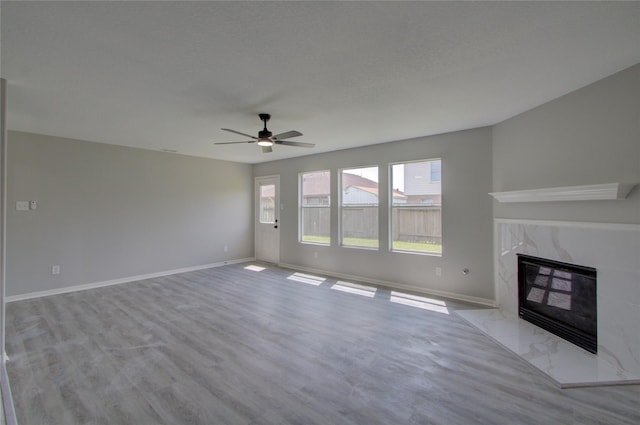 11623 Silent Elm St, Houston, TX 77044 - unfurnished living room with ceiling fan, baseboards, wood finished floors, and a fireplace