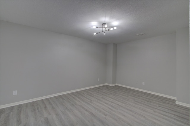 11623 Silent Elm St, Houston, TX 77044 - unfurnished room featuring wood finished floors, a textured ceiling, and baseboards