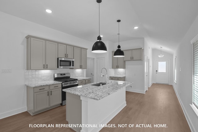 20526 Draper Rd, Tomball, TX 77377 - kitchen with appliances with stainless steel finishes, a sink, gray cabinetry, wood finished floors, and vaulted ceiling