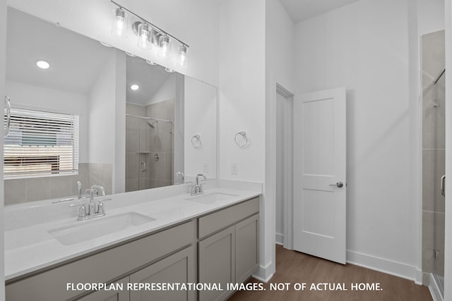 20526 Draper Rd, Tomball, TX 77377 - bathroom featuring a stall shower, wood finished floors, double vanity, and baseboards